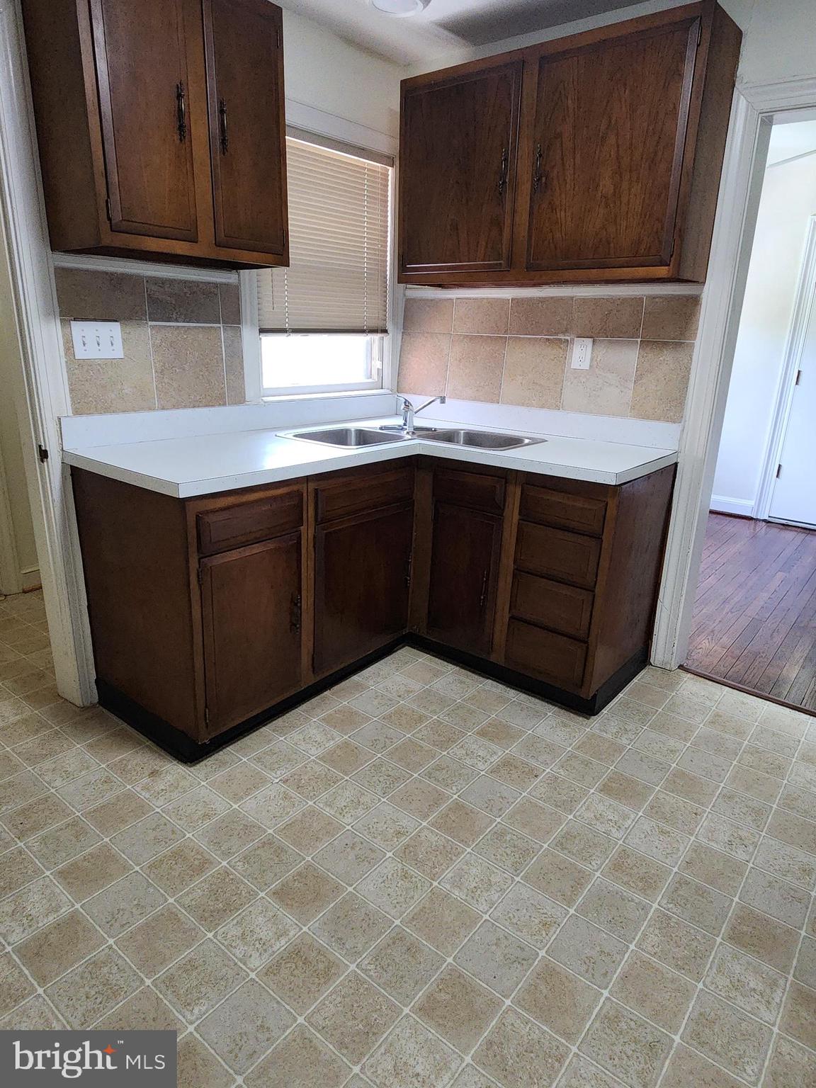 7465 Oakland Mills Road Columbia, MD 21046 - Photo 5 of 23 a kitchen with cabinets and window