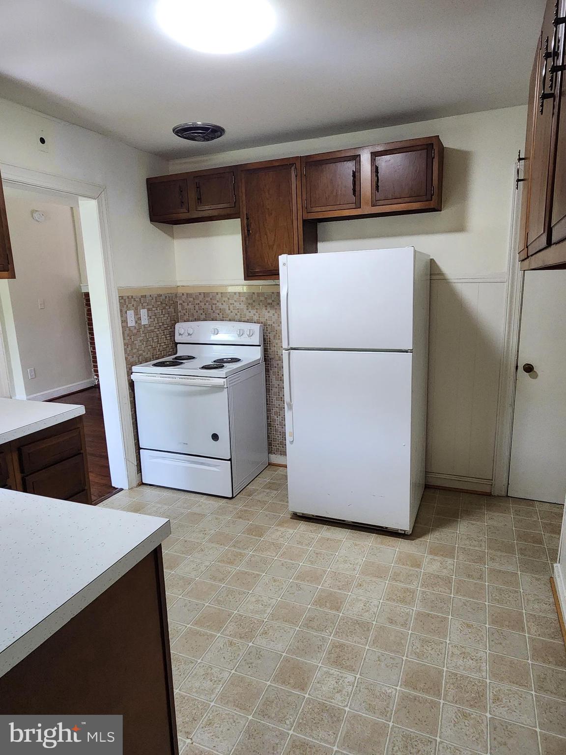 7465 Oakland Mills Road Columbia, MD 21046 - Photo 7 of 23 a kitchen with a cabinets and white appliances
