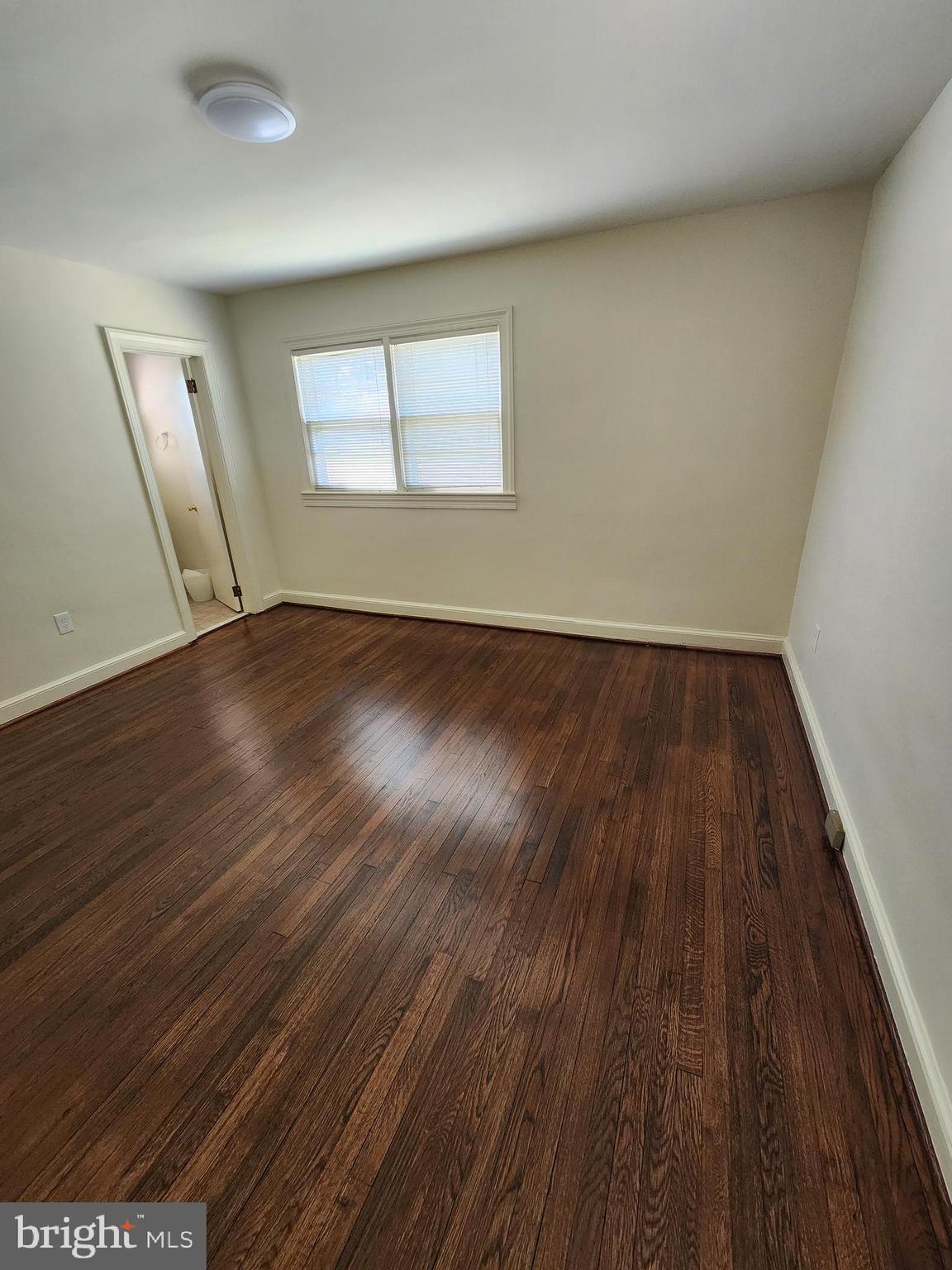7465 Oakland Mills Road Columbia, MD 21046 - Photo 9 of 23 an empty room with wooden floor and windows