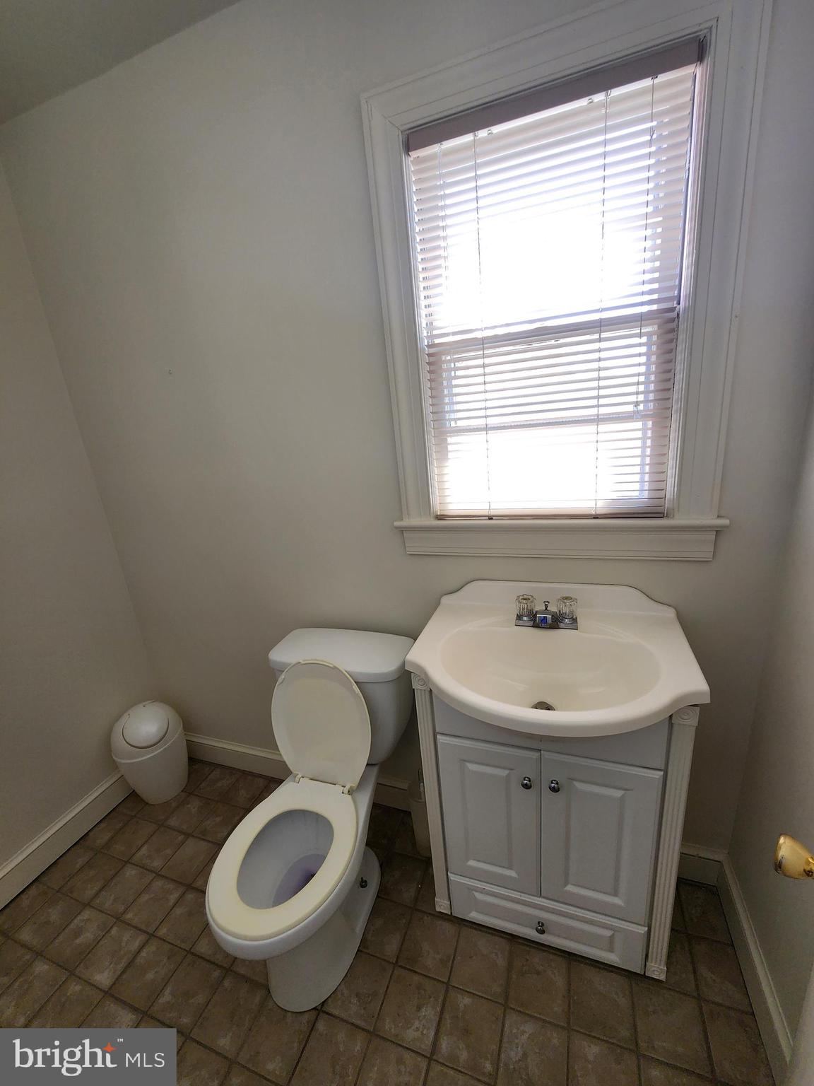 7465 Oakland Mills Road Columbia, MD 21046 - Photo 10 of 23 a bathroom with a sink toilet and window
