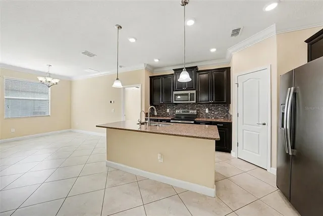 a large kitchen with cabinets and stainless steel appliances