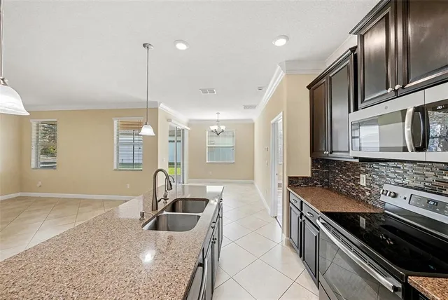 a kitchen with stainless steel appliances granite countertop a stove and a sink