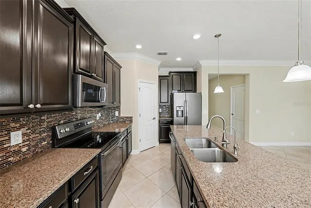 a kitchen with a stove a sink and a refrigerator