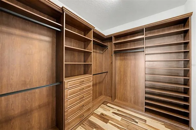 a view of walk in closet with empty racks
