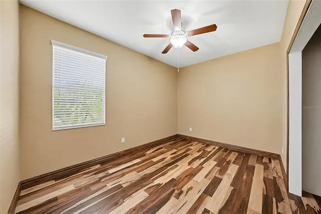 a view of a room with a ceiling fan