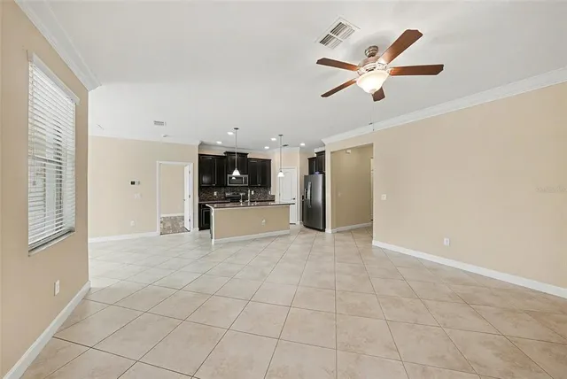 a view of a livingroom with a ceiling fan and window