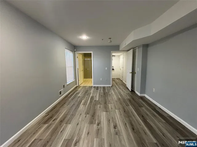 a view of a room with wooden floor and window