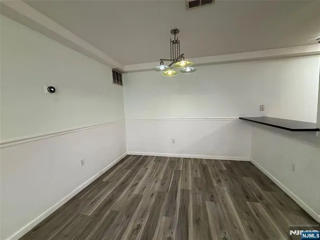 a view of a room with wooden floor fan and window