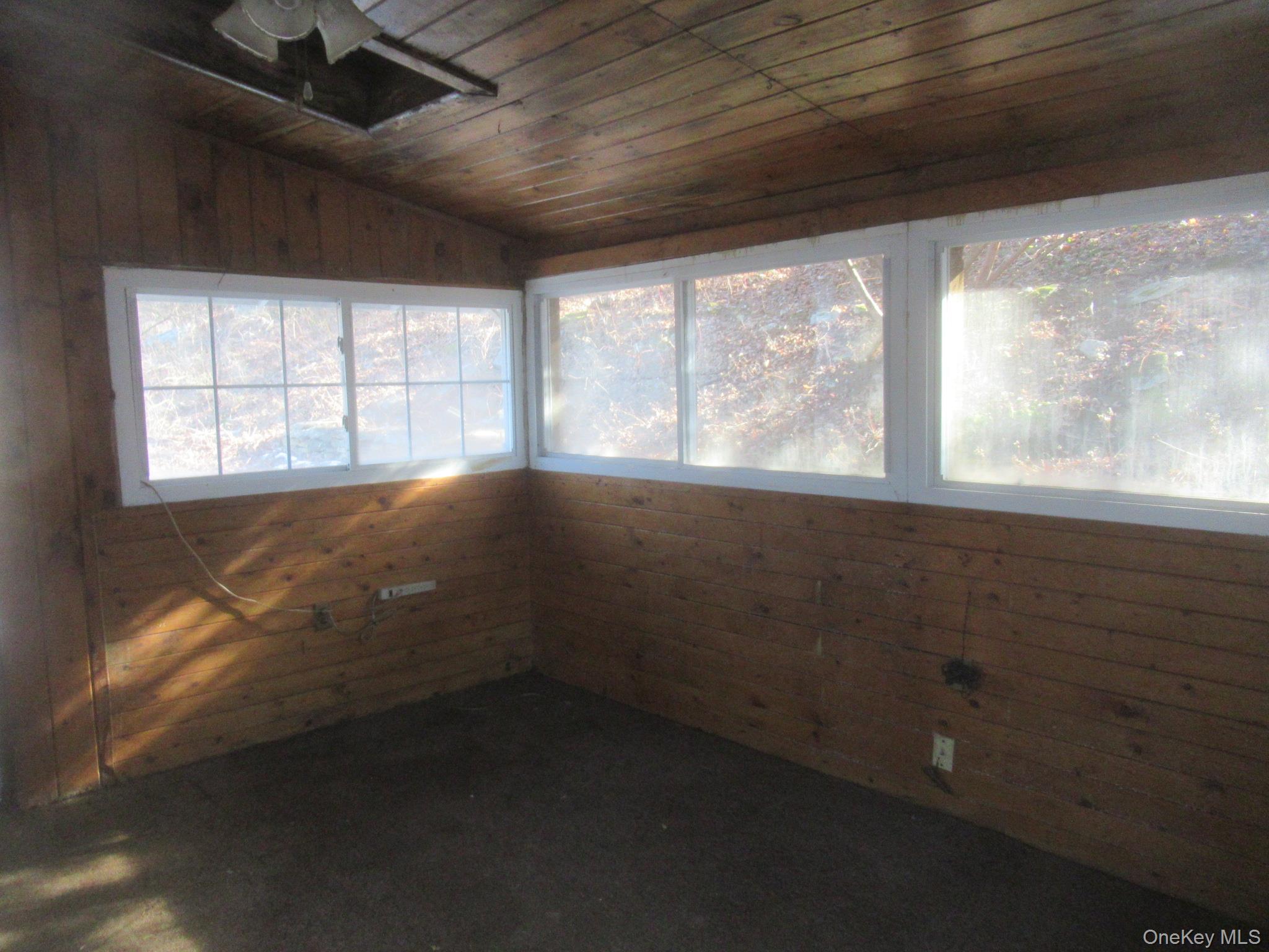 270 Bucks Hollow Road Mahopac, NY 10541 - Photo 8 of 11 Unfurnished sunroom featuring lofted ceiling, wood ceiling, and wood walls