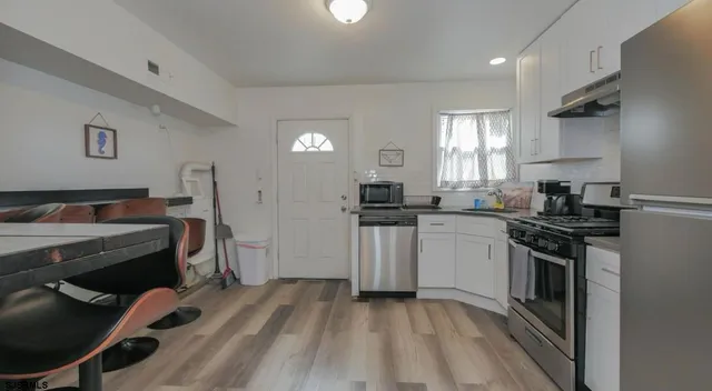 a kitchen with a sink appliances and cabinets