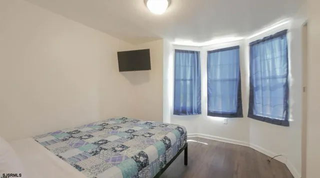 a bedroom with a bed and a tv