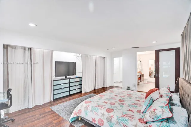 a bedroom with a bed and a television