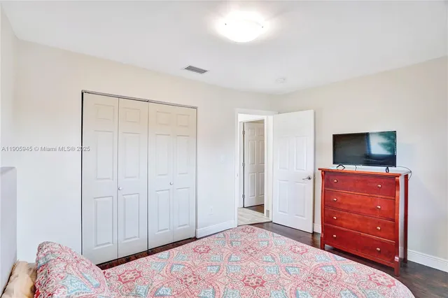 a bedroom with a bed and a television