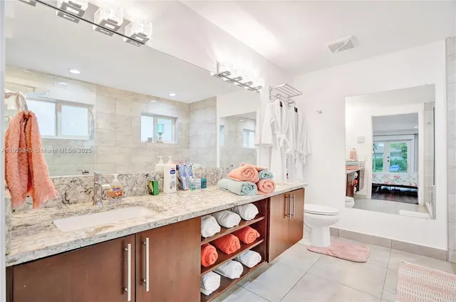 a bathroom with a tub sink and mirror