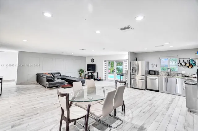 a dining room with furniture and wooden floor