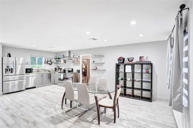 a living room with furniture a rug and white walls