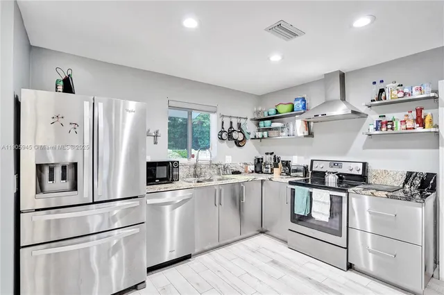 a kitchen with white cabinets and white appliances