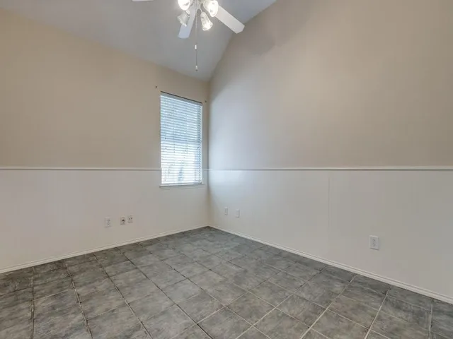 an empty room with a empty space and a ceiling fan