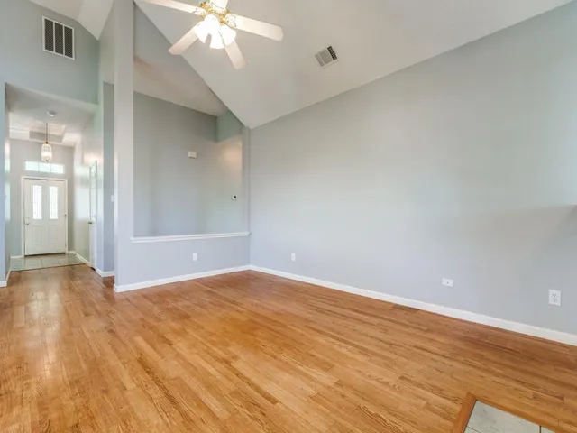 wooden floor in an empty room with a window