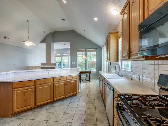 a kitchen with a sink stove and cabinets