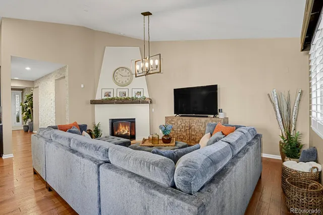 a living room with furniture a fireplace and a flat screen tv