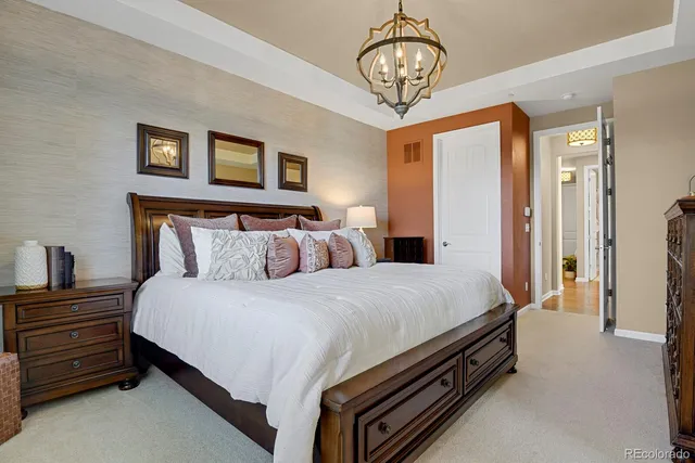 a bed room with a bed and a chandelier