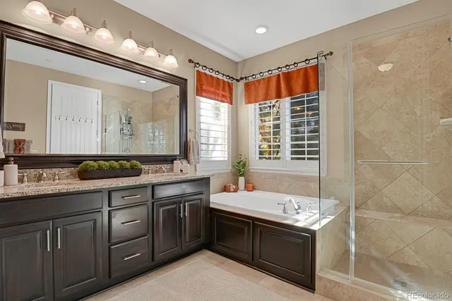 a spacious bathroom with a double vanity sink mirror and double