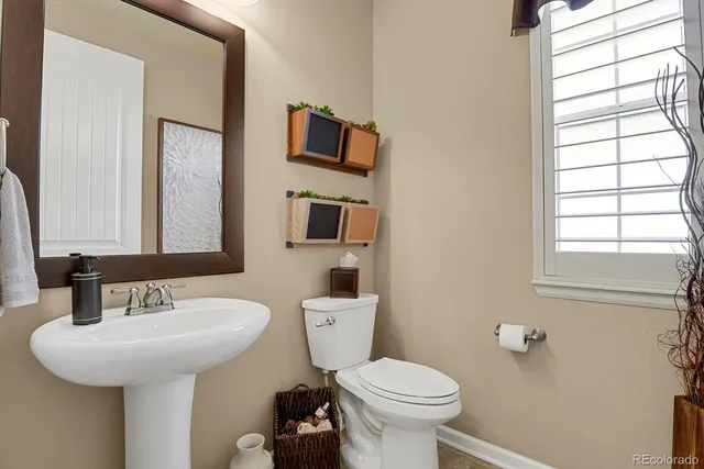 a bathroom with a sink toilet and mirror