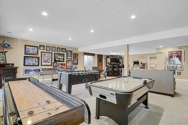 a living room with stainless steel appliances furniture and a view of kitchen