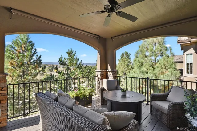 a balcony with furniture and potted plants