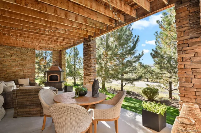 a view of a patio with couches table and chairs and potted plants