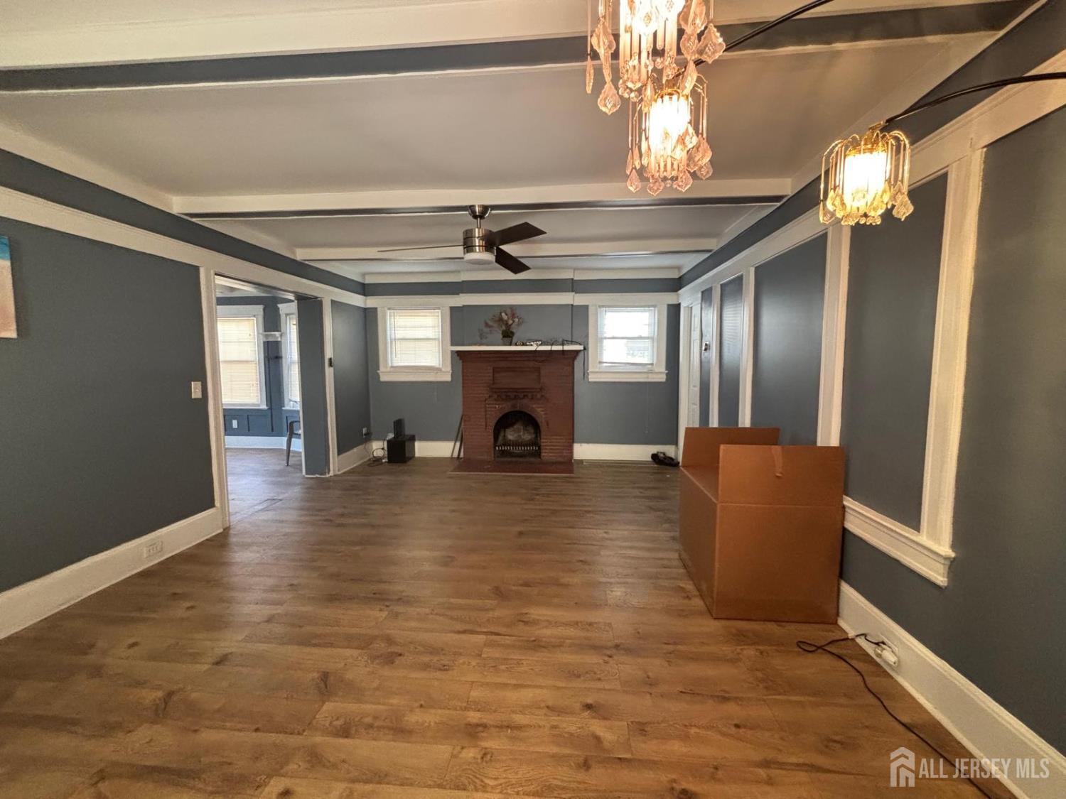 220 South Washington Avenue Dunellen, NJ 08812 - Photo 9 of 21 a view of livingroom with fireplace chandelier and wooden floor