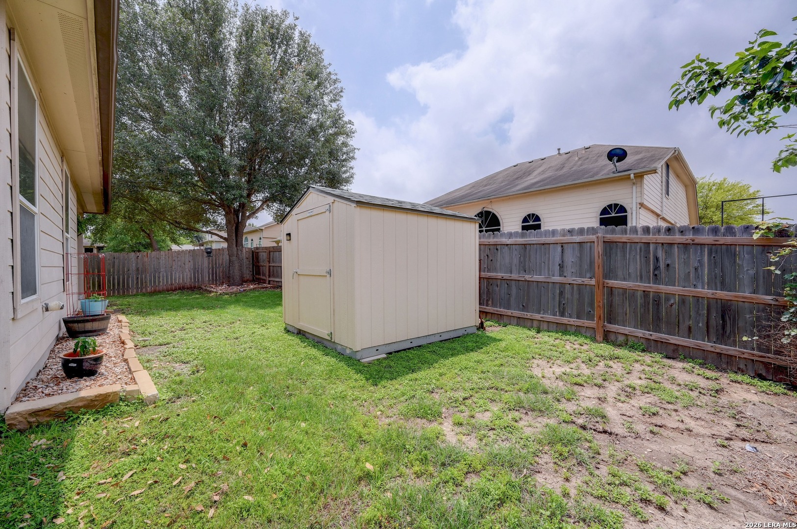 720 Hollow Ridge Schertz, TX 78108 - Photo 24 of 27 a view of backyard with a garden and deck