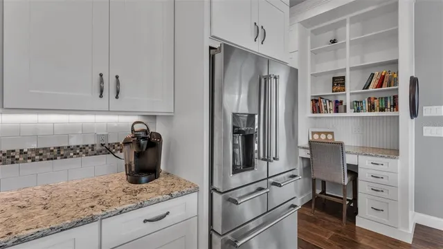 a kitchen with counter top space and stainless steel appliances