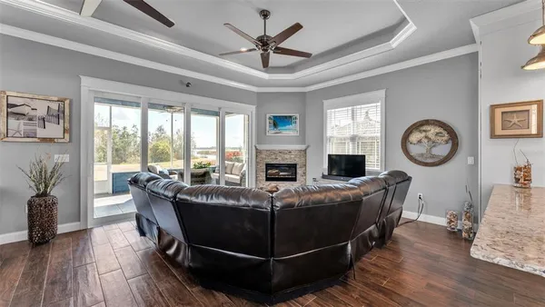 a living room with furniture a flat screen tv and a fireplace