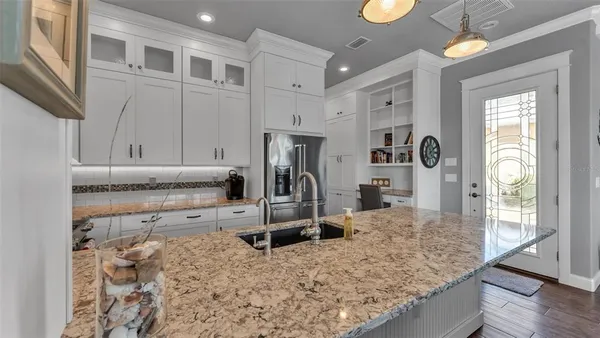 a living room with furniture fireplace and a large window