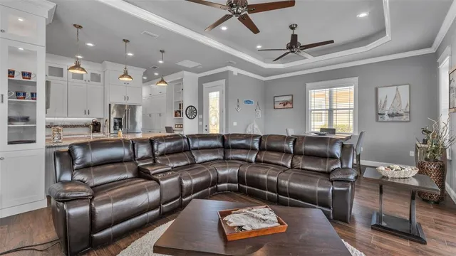 a living room with furniture a large window and a fireplace