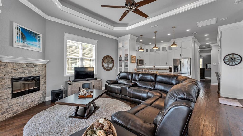 3272 Fish Hawk Drive Polk City, FL 33868 - Photo 20 of 38 a living room with furniture a large window and a fireplace