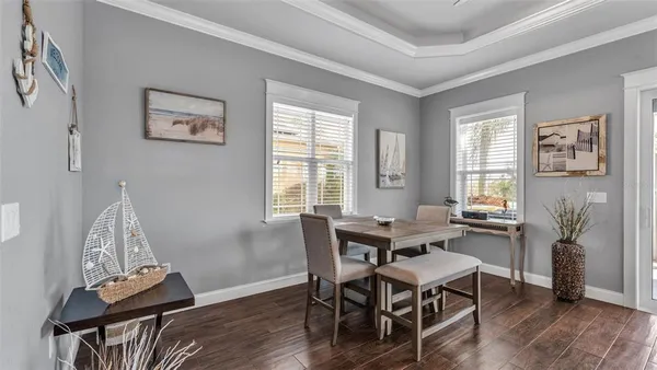 a view of cabinets with wooden floor and wall painting