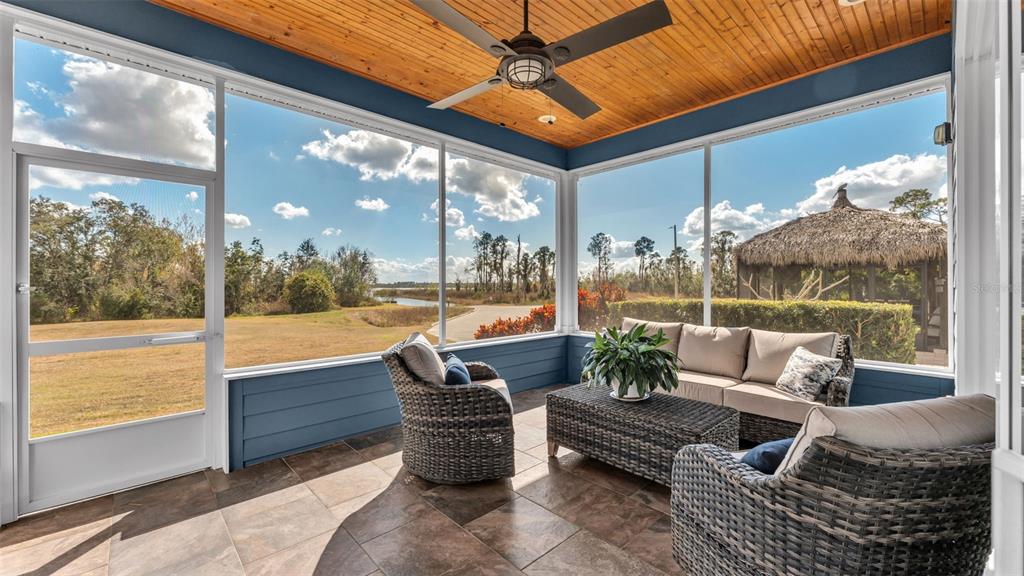3272 Fish Hawk Drive Polk City, FL 33868 - Photo 35 of 38 a outdoor living space with furniture and a floor to ceiling window