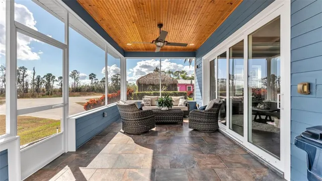 a living room with furniture floor to ceiling window and wooden floor