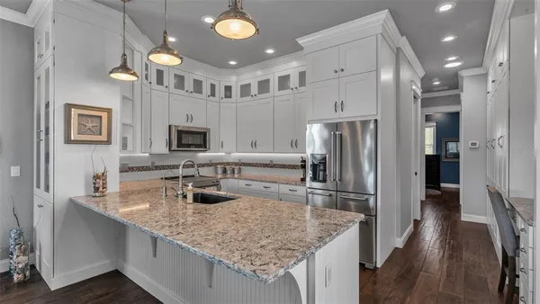 a kitchen with stainless steel appliances granite countertop a stove and a sink