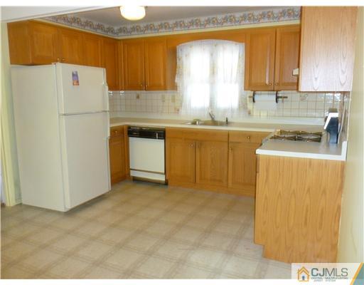 24 Summerall Road Somerset, NJ 08873 - Photo 14 of 24 a kitchen with refrigerator cabinets and a sink