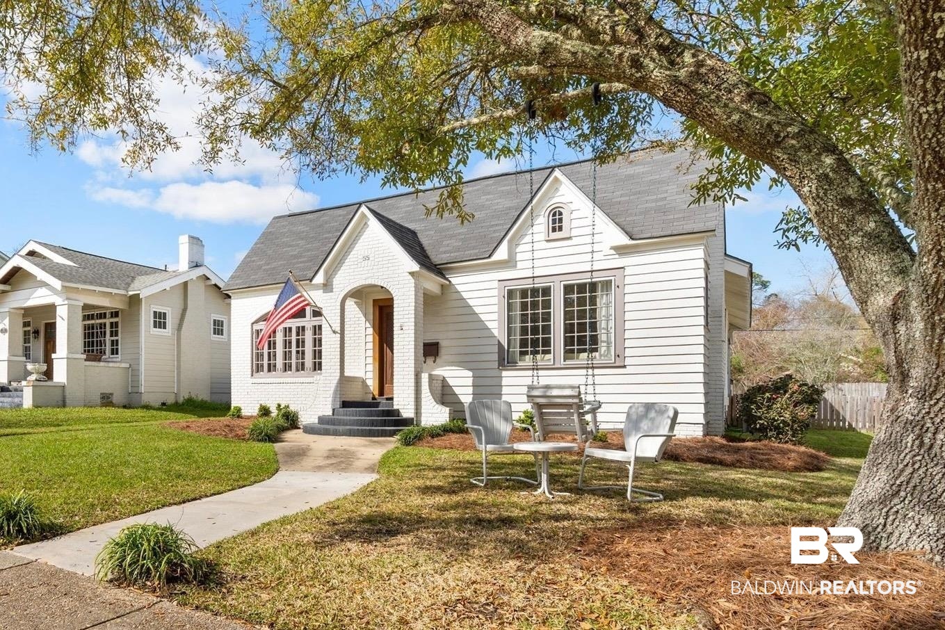 55 Silverwood Street Mobile, AL 36607 - Photo 2 of 31 View of front of house featuring a front lawn, fence, and brick siding