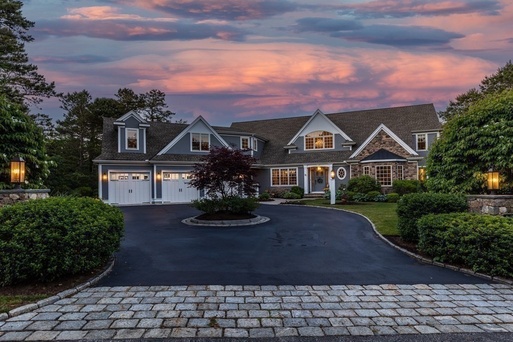 a front view of a house with yard and green space