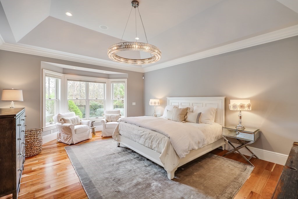 43 Boulder Ridge Plymouth, MA 02360 - Photo 19 of 42 a bedroom with a bed and a chandelier