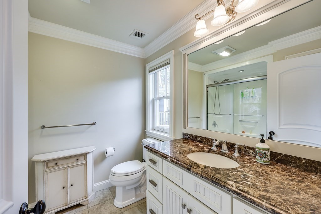 43 Boulder Ridge Plymouth, MA 02360 - Photo 29 of 42 a bathroom with a granite countertop sink a toilet and a mirror