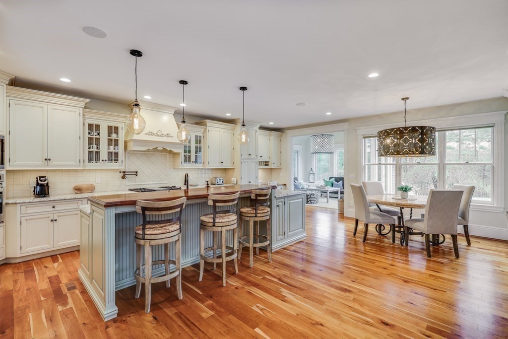 43 Boulder Ridge Plymouth, MA 02360 - Photo 9 of 42 a kitchen with stainless steel appliances kitchen island granite countertop a wooden floor and white cabinets