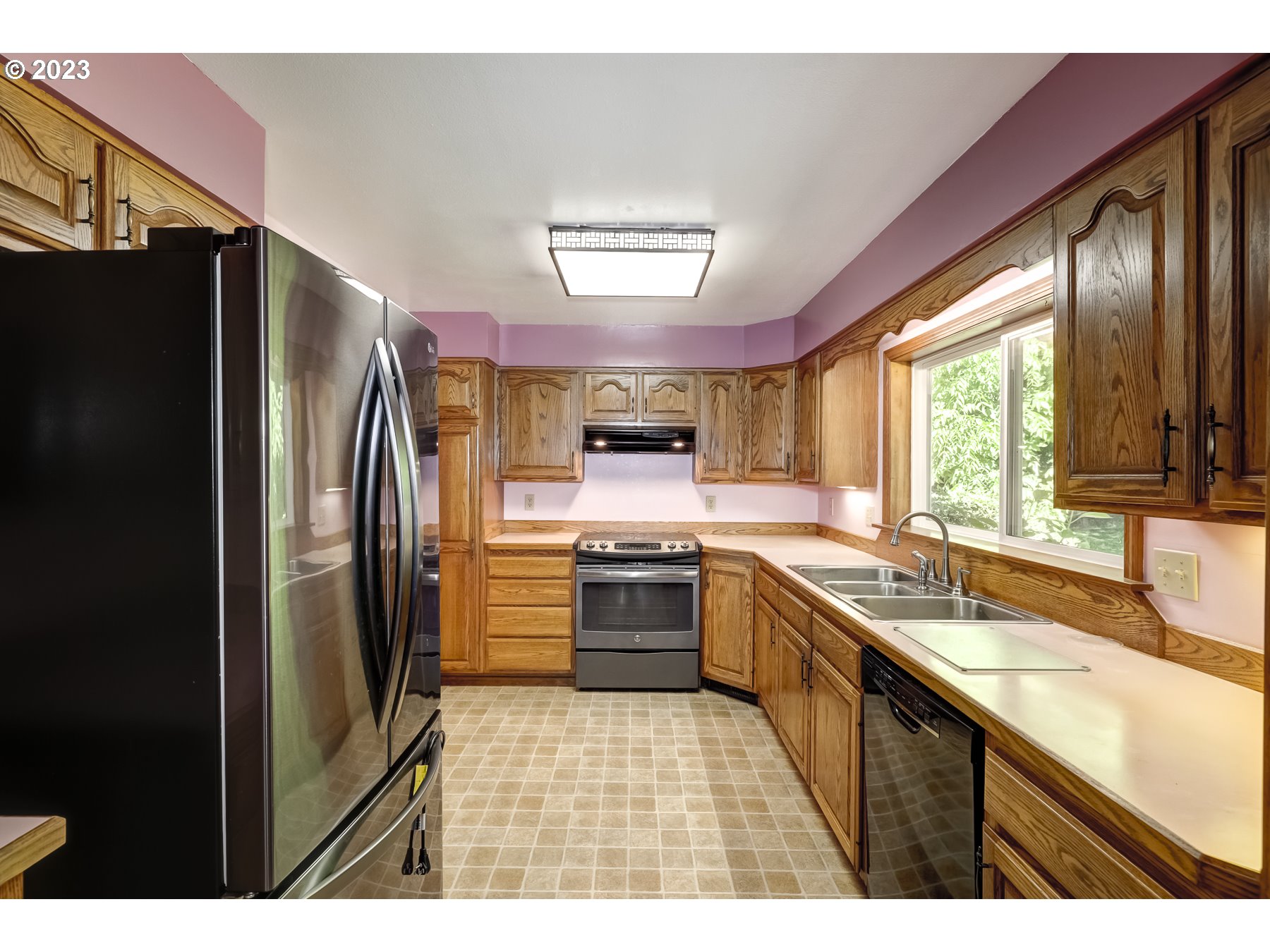 13100 Northwest Willis Road McMinnville, OR 97128 - Photo 11 of 38 a kitchen with stainless steel appliances granite countertop a refrigerator a sink dishwasher a stove and a oven with wooden floor