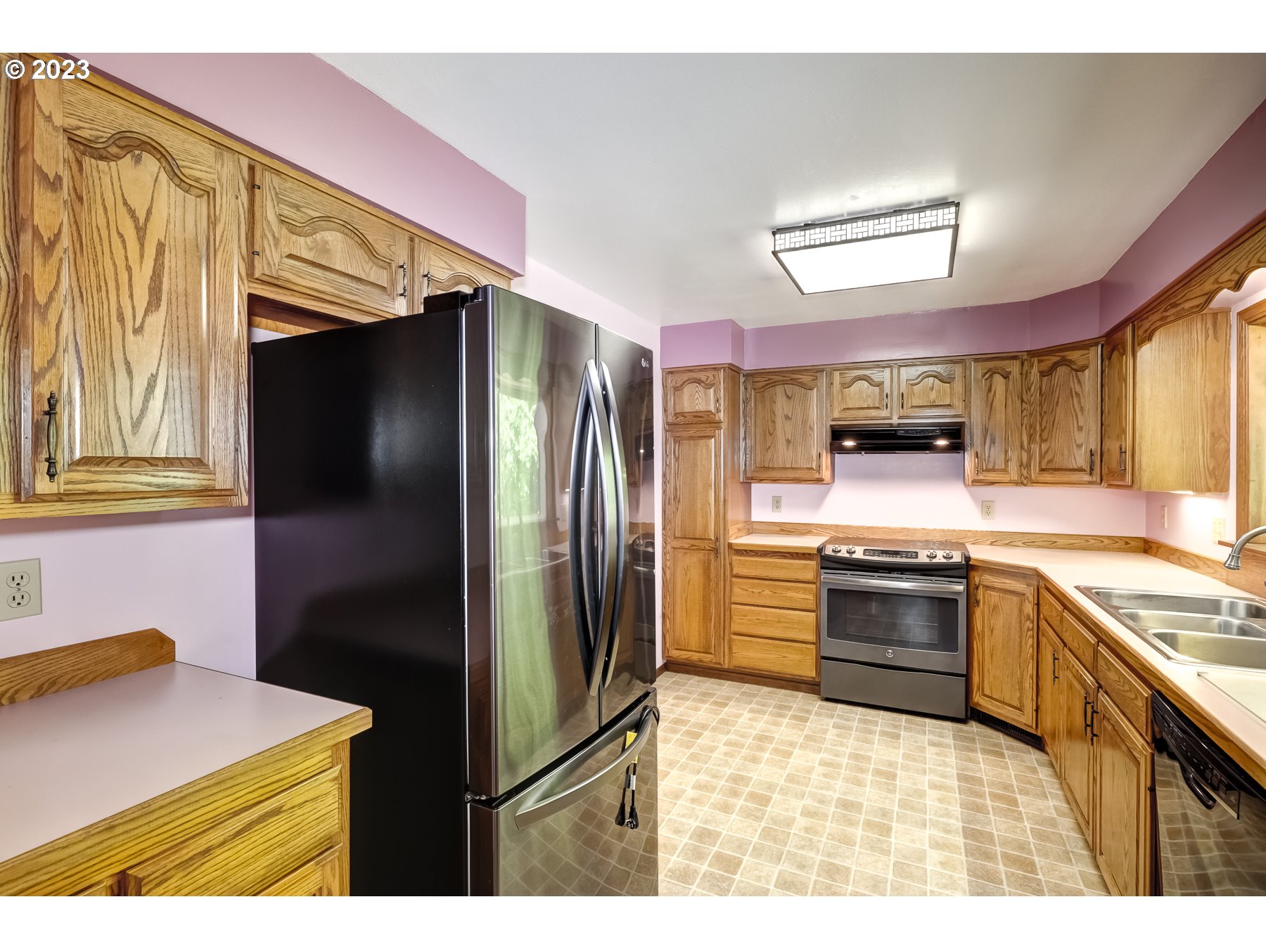 13100 Northwest Willis Road McMinnville, OR 97128 - Photo 12 of 38 a kitchen with stainless steel appliances granite countertop a refrigerator and a stove top oven